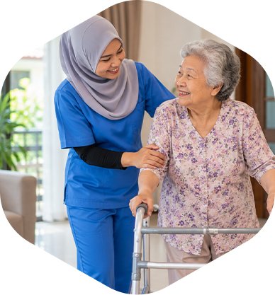 Caregiver assisting an elderly woman with walking